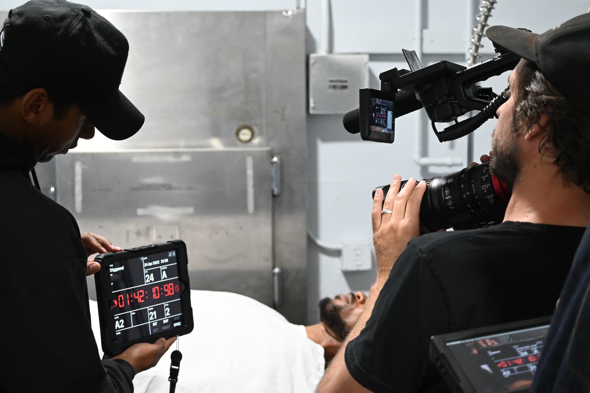 Montage Media Production Company crew, camera and sound team filming a clinical interior scene, on a production overseen by E'Ian West