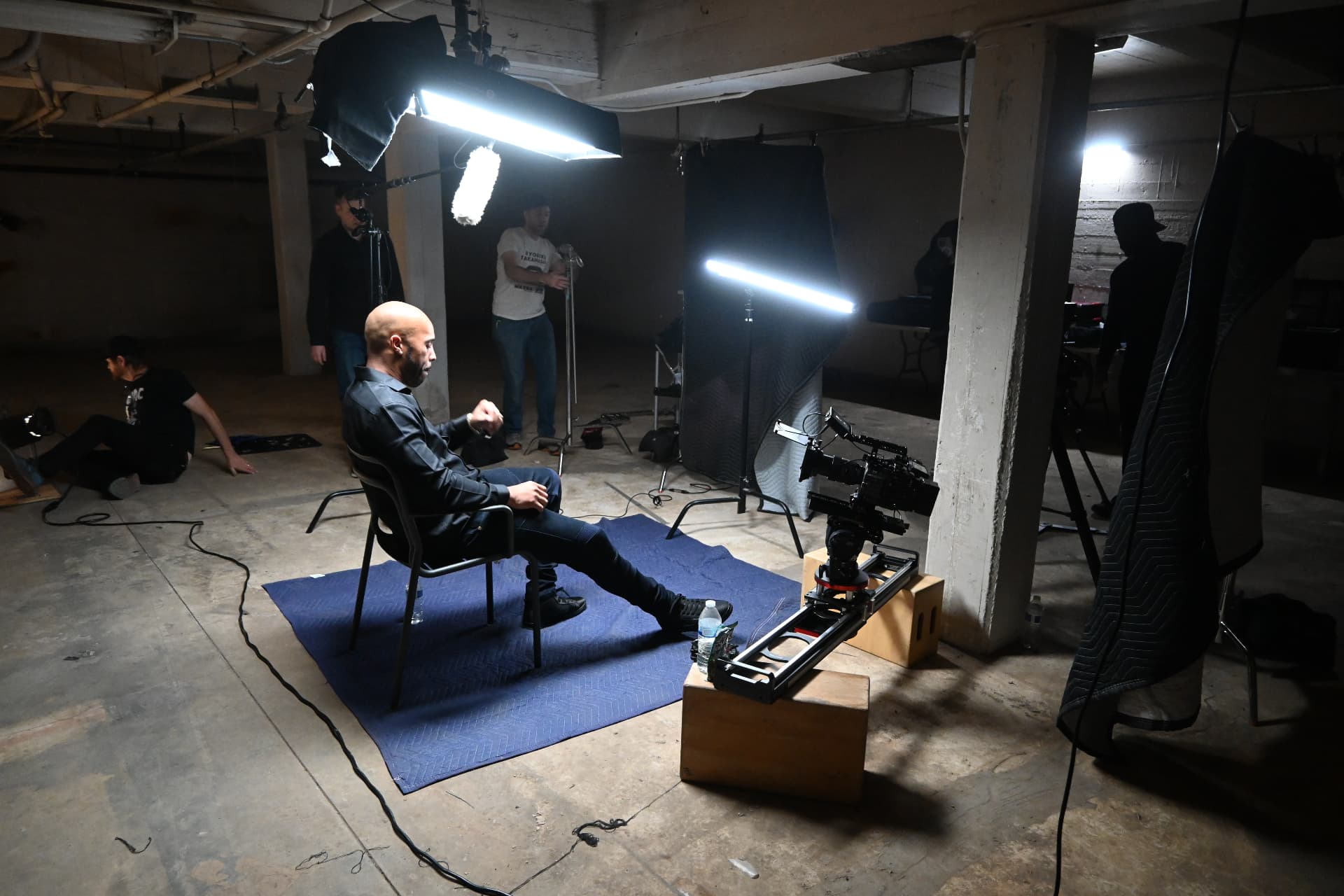 Behind the scenes with Montage Media Production Company: Key light and boom on the seated subject