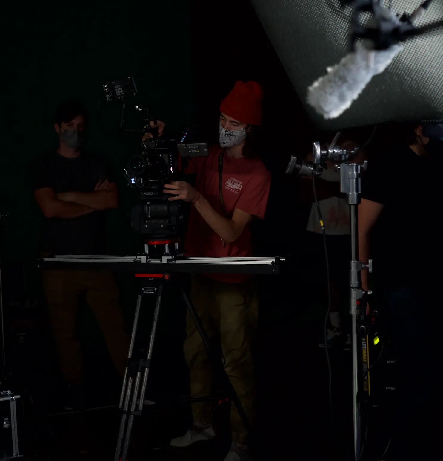Slider mounted camera and crew on a darkened stage, photographed on location with E'Ian West and the Montage Media Production Company team