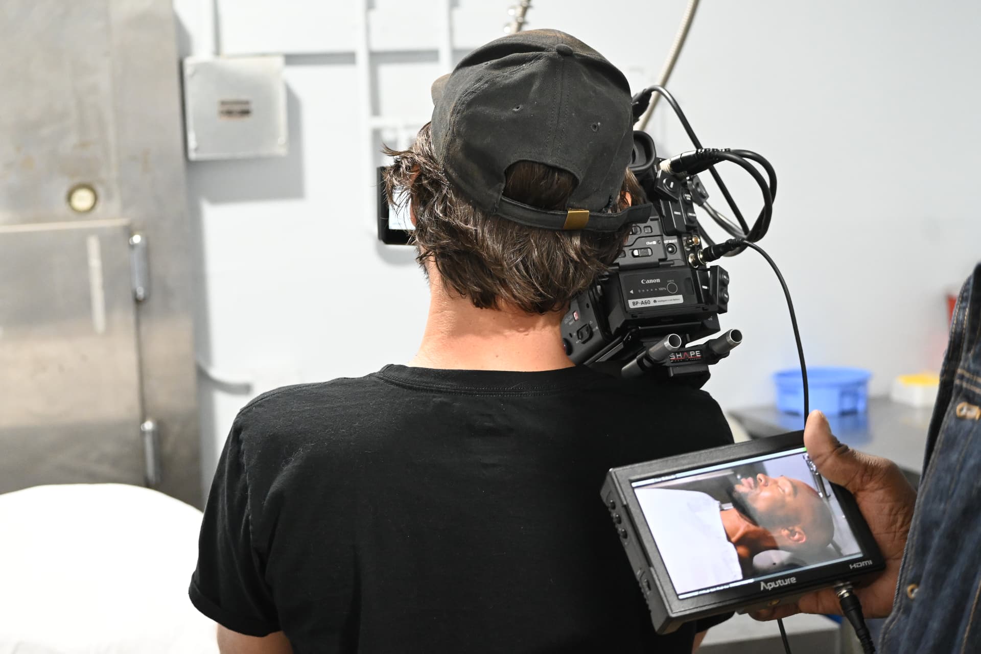 Shoulder camera and field monitor during an interior take, photographed on location with E'Ian West and the Montage Media Production Company team