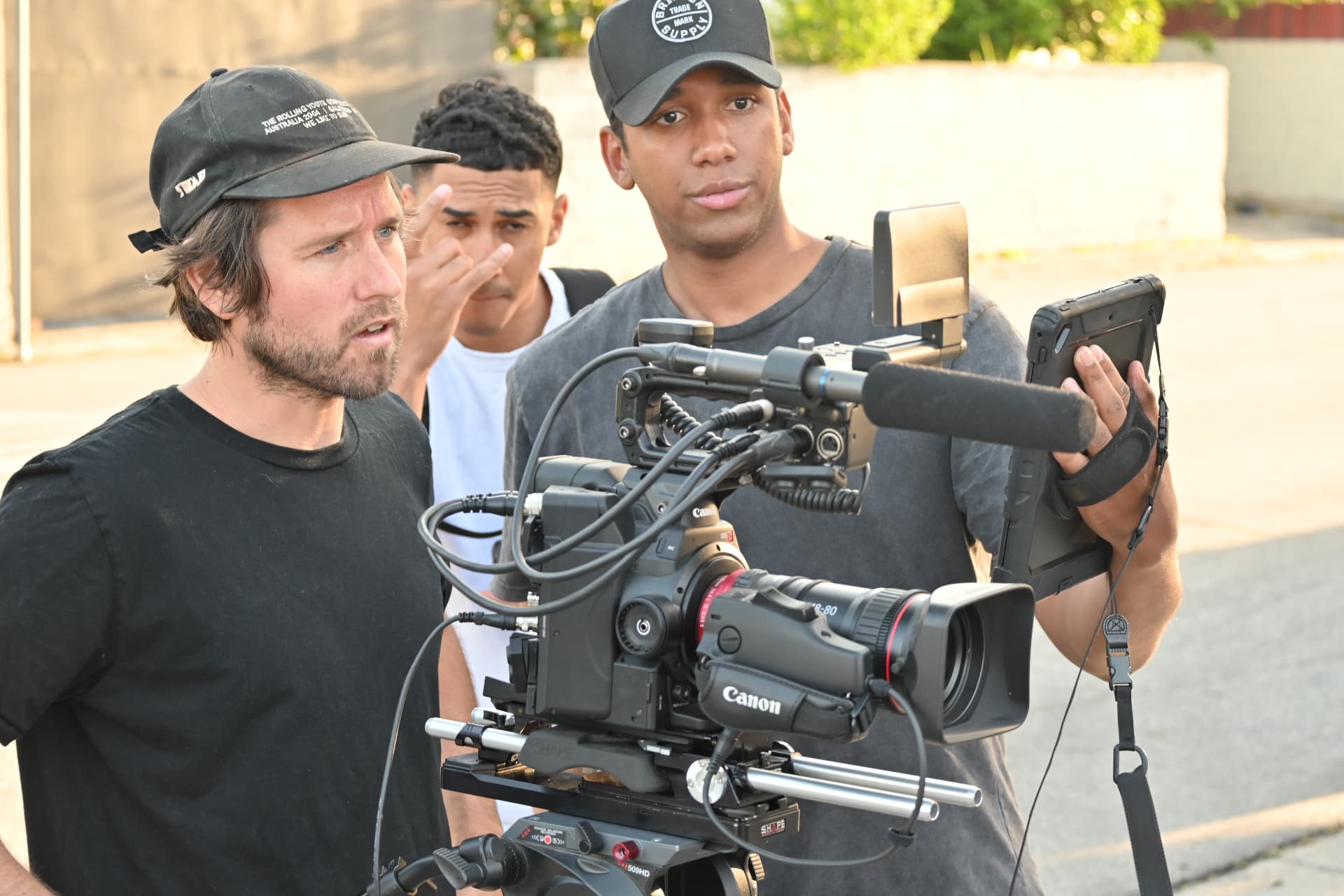 Camera team reviewing an exterior production setup on a Montage Media Production Company set led by E'Ian West