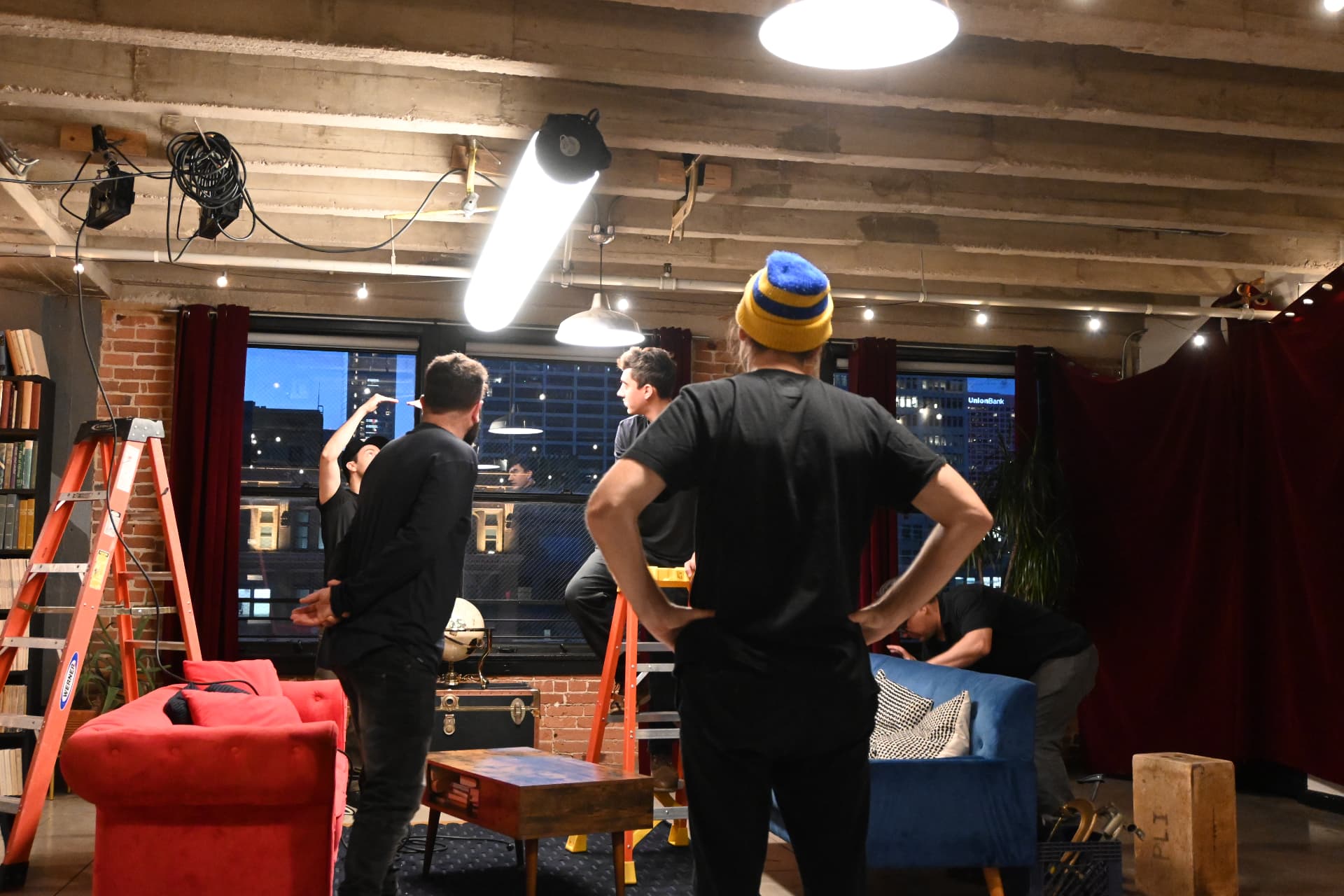 Behind the scenes with Montage Media Production Company: Crew resetting the loft set between takes