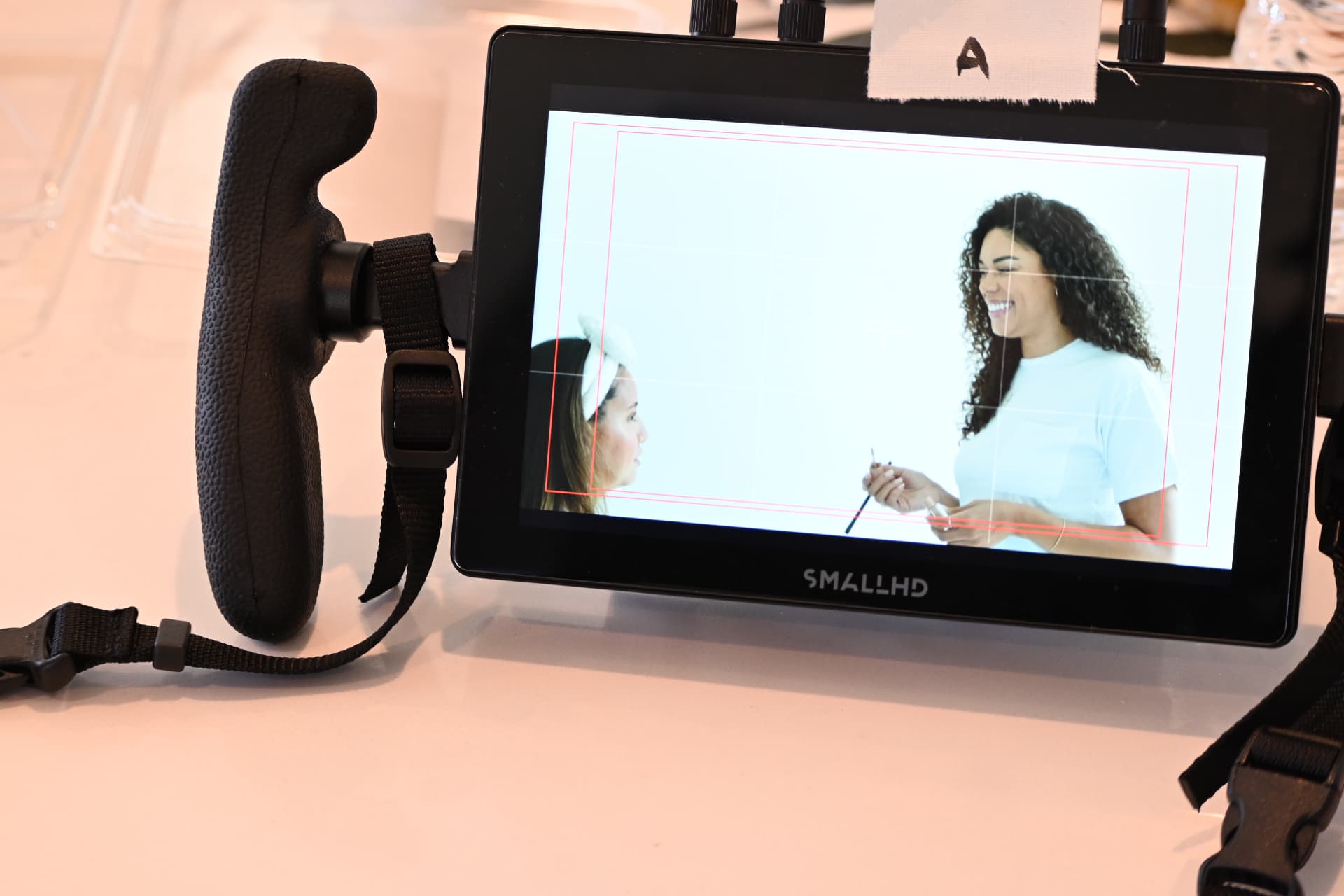 Behind the scenes with Montage Media Production Company: Field monitor framing a two hander on a white cyc