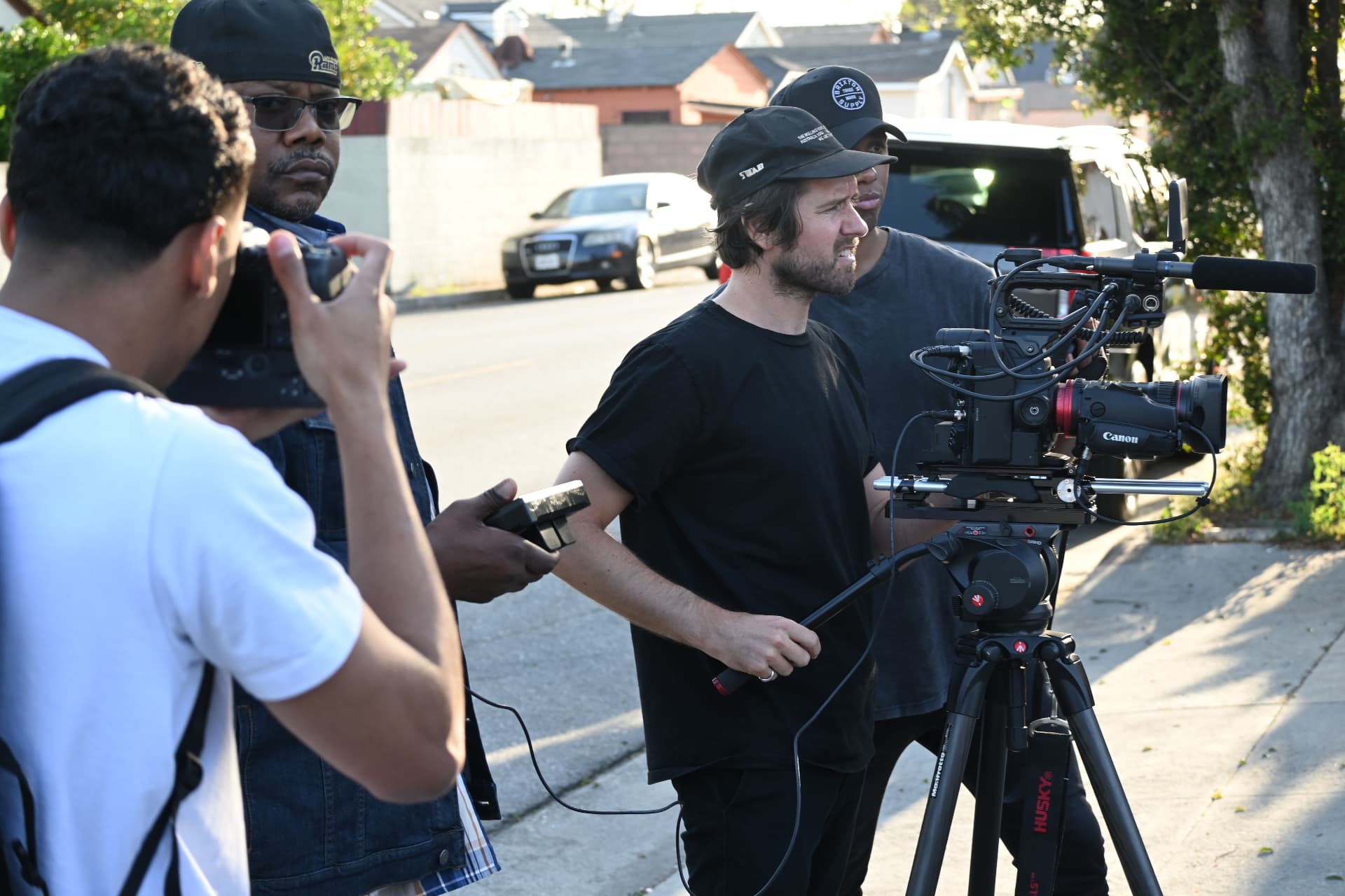 Behind the scenes with Montage Media Production Company: Crew lining up a shot on a residential street