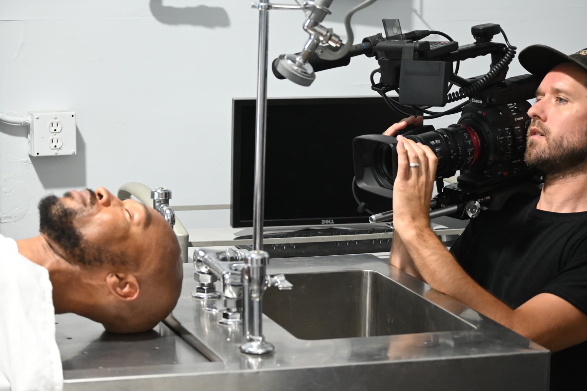 Camera operator framing a close up in a clinical set on a Montage Media Production Company set led by E'Ian West